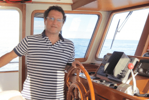 ASA certified sailboat instructor providing hands-on sailing training and instruction.
