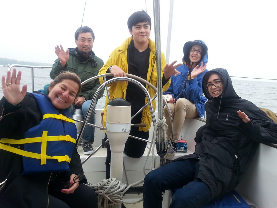 Group of friends enjoying sailing trip.