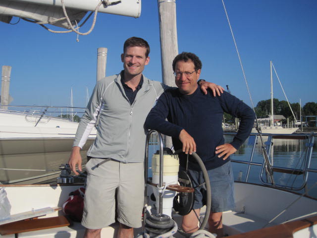 Two men posing on a boat.